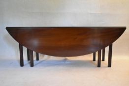 A Georgian style mahogany wake table of rounded rectangular form with a moulded edge. The drop flaps