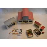 A group of vintage farmyard buildings along with a collection of lead figures, animals, farm
