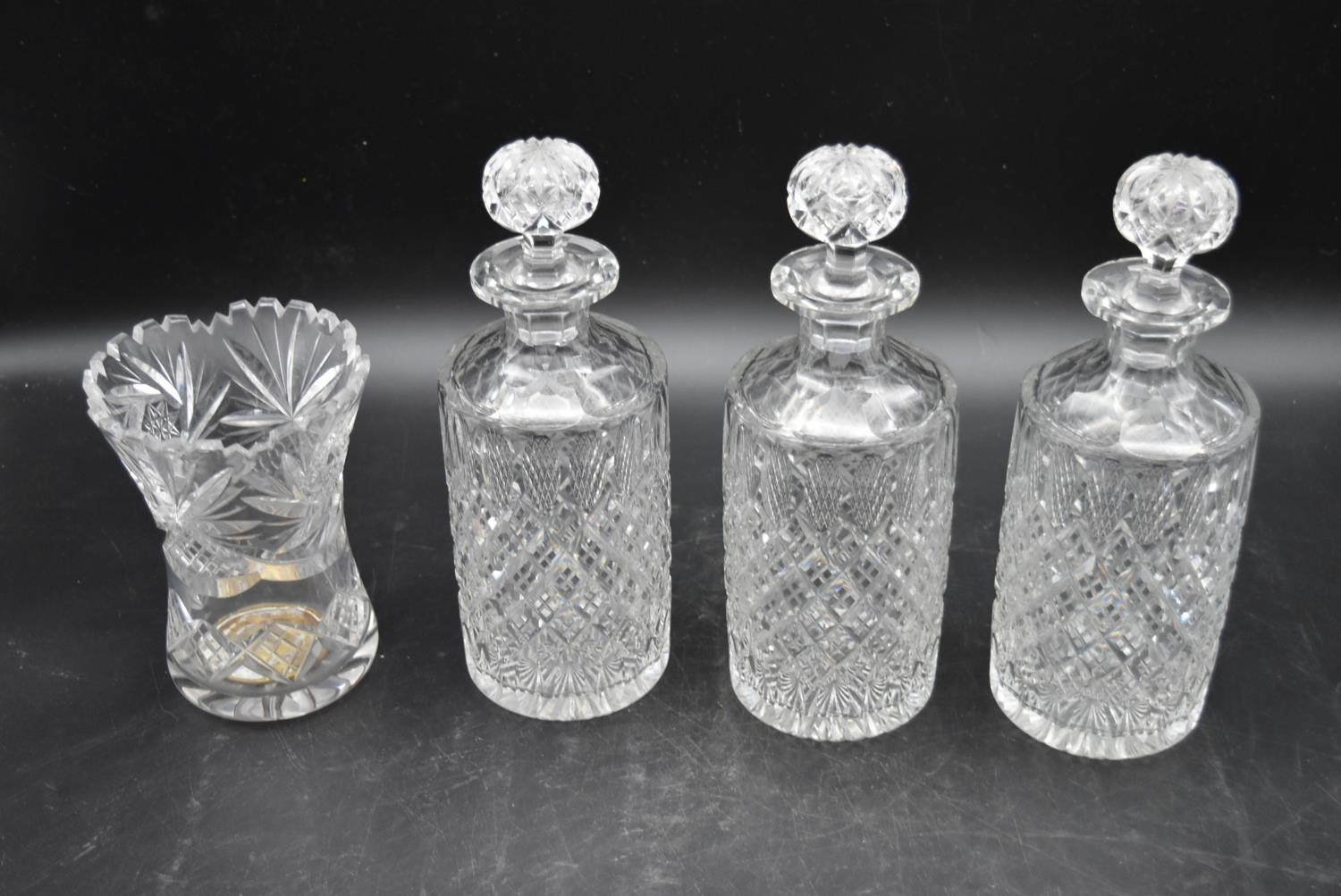 A set of three 20th century cut crystal glass topped decanters with a similar vase. H.27cm ( - Image 2 of 7