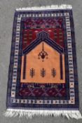 A hand made Zekhani Belouch prayer rug with sand and burgundy ground within geometric borders. L.170
