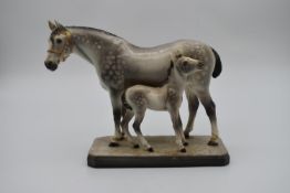 A Goldscheider figure group, mare and foal, marked to base. H.25 W.24 D.10cm
