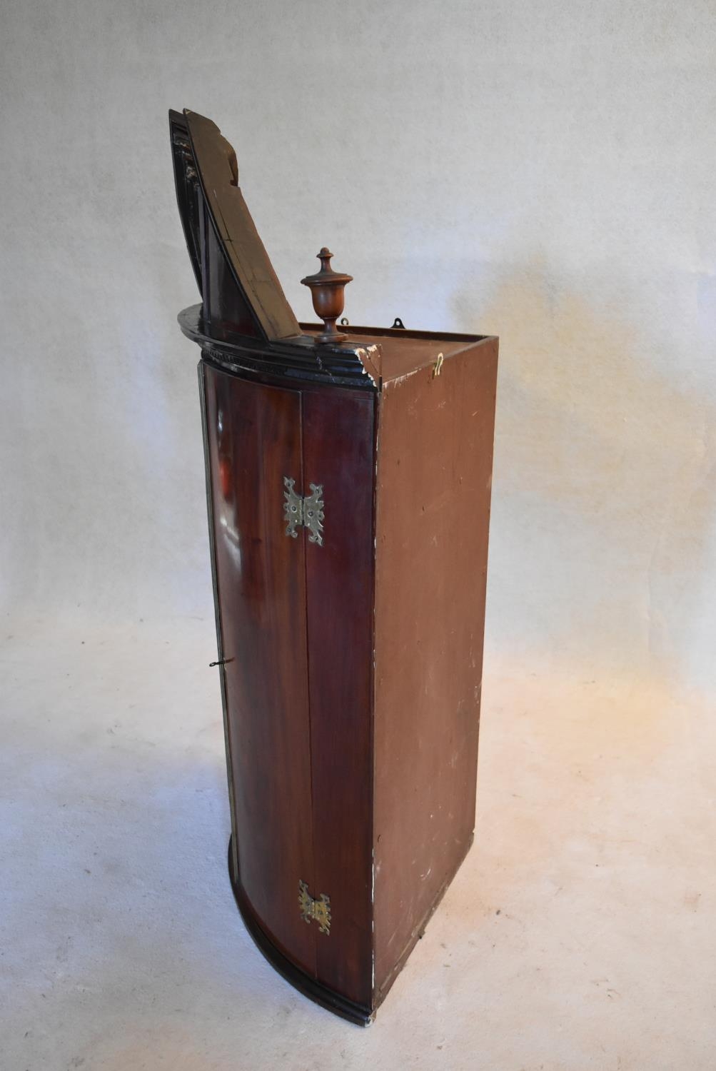 A Georgian mahogany bowfronted hanging corner cabinet with arched pediment and urn finials and - Image 8 of 10