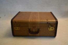 A vintage leather bound travelling case with fitted interior and fold out hanging rail, maker's