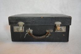 A vintage leather travelling case with gilt embossed monogram. H.24 W.44 D.33cm