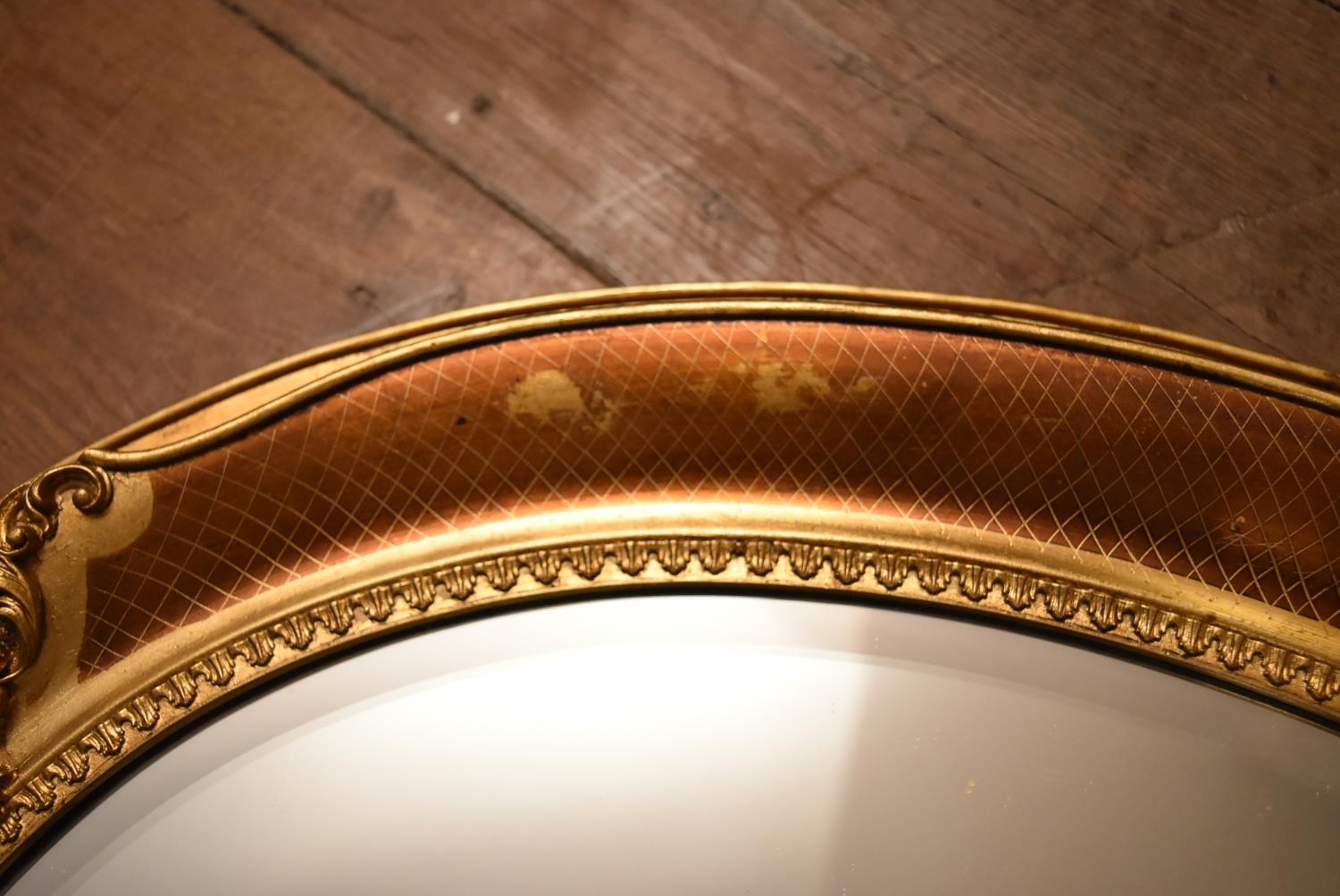 A contemporary oval wall mirror in gilt floral decorated frame. H.66 W.86cm - Image 5 of 10