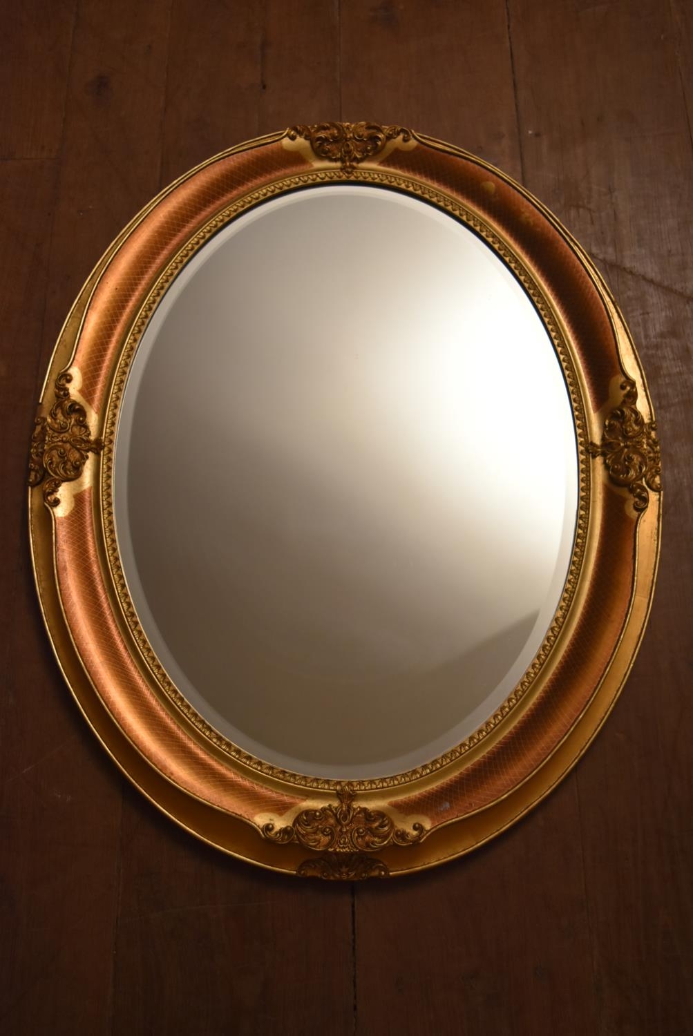 A contemporary oval wall mirror in gilt floral decorated frame. H.66 W.86cm - Image 4 of 10