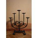 A 20th century five branch iron candelabra, stylised with twist branches and swirl design. H.54 W.