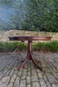 A Regency style mahogany card table with gilt tooled leather inset top on swept supports. H.73 Dia.