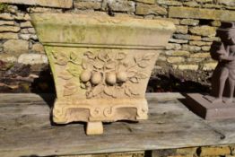 A Willowstone reconstituted stone garden planter with fruit and leaf relief decoration.