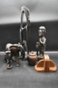 A carved hardwood tribal figure, other carved figures, a coconut vase and a pair of vintage oak