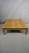 A contemporary light oak low table on square tapering supports. H.31 W.90 D.90