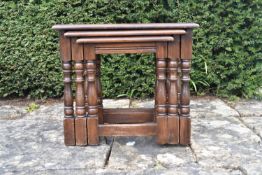 A nest of mid century oak occasional tables on turned stretchered supports. H.48 W.55 D35cm