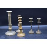Two pairs of 19th century brass candlesticks and a similar single stick. H.28cm