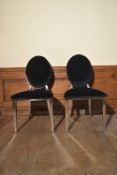 A pair of contemporary chrome framed dining chairs with upholstered backs and seats. H.94 W.45cm