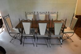 A vintage dining table with planked and cleated top on wrought metal X frame base along with eight