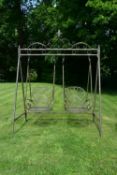 A Victorian style metal framed garden swing with twin scrolling tub armchair seats. H.223 W.180cm