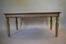 A distressed limed oak low table on square tapering fluted supports. H.52 W.118 D.67cm