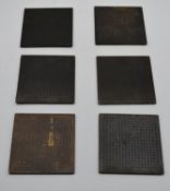 A set of six small bronze place mats impressed with Chinese character marks. H.15 W.15cm