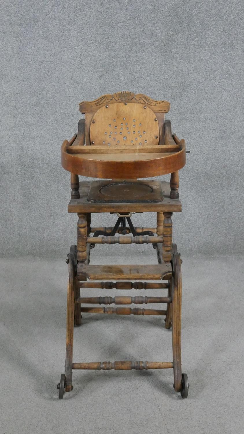 A late 19th century carved beech child's high chair converting to baby walker. H.87 W.39 D.61cm