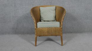 A vintage Lusty Lloyd Loom tub chair with makers label.