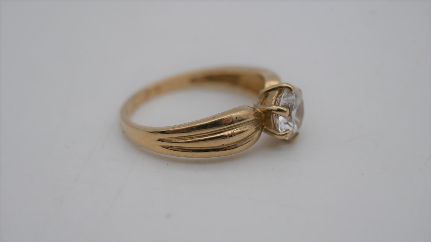 A cubic zirconia and 9 carat gold solitaire ring. Set to centre with a round brilliant cut cubic - Image 2 of 7