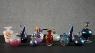 A collection of art glass scent bottles and candlesticks, various makers such as Mdina, Isle of