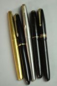 A collection of five gold-nibbed vintage fountain pens, including an 18 carat gold-nibbed
