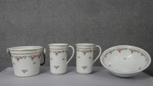 A four piece Victorian ceramic wash set, each decorated with a rose design. Numbered to the base.