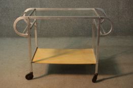A vintage metal trolley with plate glass top and under tier on wheel casters. H.64 W.90cm
