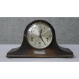 A vintage oak cased mantle clock with silver inscribed presentation plaque. Silvered dial and