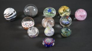 A collection of twelve lamp work limited edition paperweights by various makers, including Verrucci,