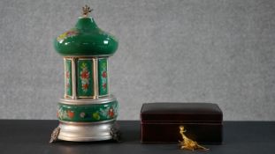 A Reuge musical anatomical carousel cigarette holder along with a leather jewellery box. H.32 Diam.