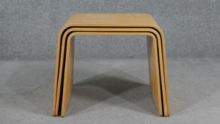 A nest of three contemporary vintage style tables in laminated plywood. H.46 W.58 D.33cm