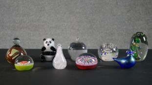 A collection of nine lamp work glass paperweights by various makers, including Langham, Heron and