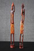 Two hand carved and painted hardwood tribal figures from Zanzibar with beaded necklace detailing.