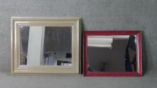 Two contemporary framed wall mirrors, one with a cream painted frame. H.70 W.85cm (largest)