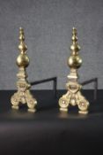A pair of Victorian brass and cast iron fire dogs with floral motifs and turned finials. H.44 W.