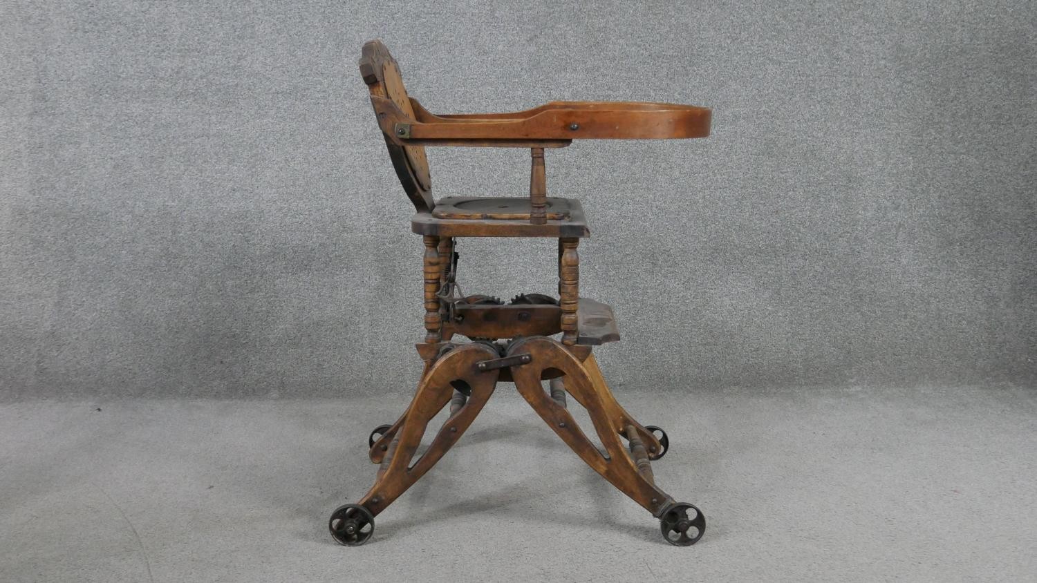 A late 19th century carved beech child's high chair converting to baby walker. H.87 W.39 D.61cm - Image 3 of 8