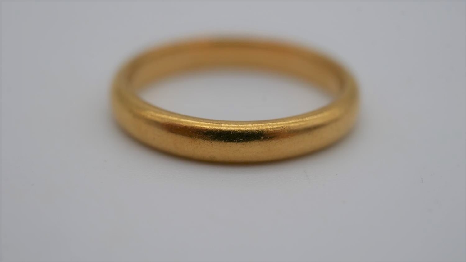 A 1920's 22 carat yellow gold D-shaped court wedding band. Hallmarked: London, 1925. Size N 1/2. - Image 3 of 6