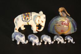 A collection of ceramics, including a family of graduated size blue and white porcelain elephants, a