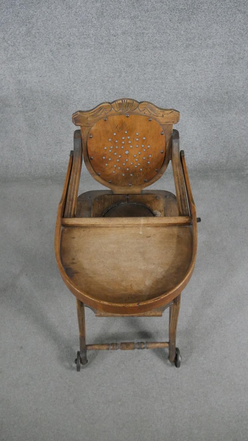 A late 19th century carved beech child's high chair converting to baby walker. H.87 W.39 D.61cm - Image 5 of 8