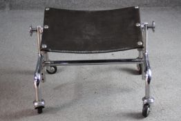 A vintage chrome framed adjustable footstool on casters, maker's mark to frame. H.33 W.45 D.35cm.