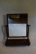 A Victorian mahogany swing frame dressing table mirror on platform base. H.75 W.61 D.28cm