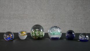 A collection of six limited edition lamp work paperweights by various makers. H.11 W.11cm (largest)