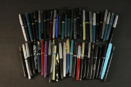 A large collection of vintage fountain pens. Various makers including Parker and Sheaffer. Approx 57