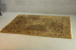 A Persian style rug with all over foliate and hunting motif decoration. L.195 W.140CM.