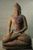 A life sized 20th century carved sandstone Buddha in Lotus position. (added oil paint design). H.