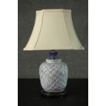 A blue and white Chinese style pineapple design table lamp, mounted on a hardwood base. H.55cm.
