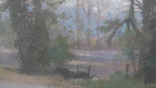 A framed and glazed pastel on paper of a field with trees, titled and signed verso Margaret