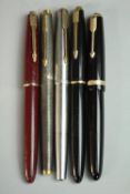 A collection of five 14 carat gold-nibbed vintage Parker fountain pens, including a Parker Duofold